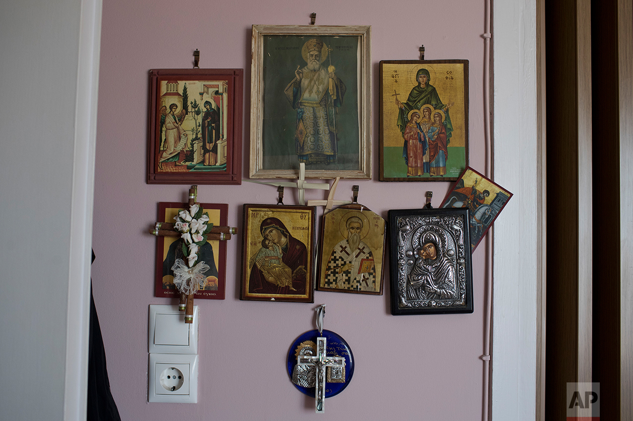  In this Monday, May 15, 2017 photo, religious icons hang in the home of Greek pensioner Mina Griva, 78, in Athens. Greek retirees say they are struggling to survive on ever dwindling pensions with repeated cuts imposed by successive governments as p