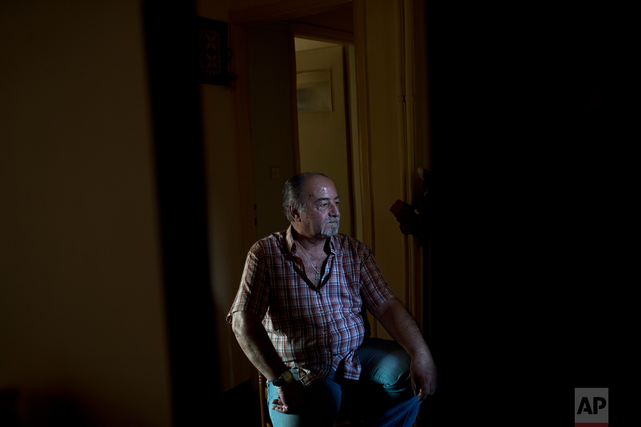  In this Monday, May 15, 2017 photo, Greek pensioner Fotis Milas, 66, a former paper factory employee, sits in his small apartment in Athens. The new austerity measures are likely to cut his pension to about 800 euros, Milas said. "I will start havin