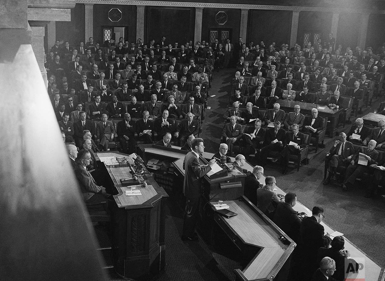  This is a partial view of the filled House of Representatives as President John F. Kennedy addresses a joint session of Congress, May 25, 1961 in Washington. Members of the diplomatic corps occupy the seats at left.  At lower left, rear of Kennedy, 