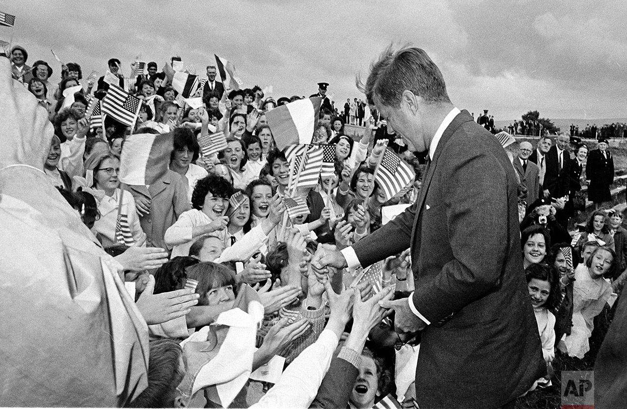  U.S. President John F. Kennedy arrives at Sean O'Kennedy soccer field and is greeted by school children waving Irish and American flags, during his visit to New Ross, Ireland, June 27, 1963. (AP Photo) 