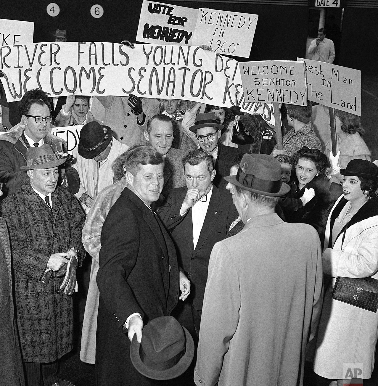  Sen. John Kennedy of Massachusetts (center, foreground) is greeted by students and state political leaders as he arrives in Minneapolis, Nov. 12, 1959 to begin a two-day tour of Minnesota and Wisconsin. Since 1956, Kennedy has criss-crossed the nati