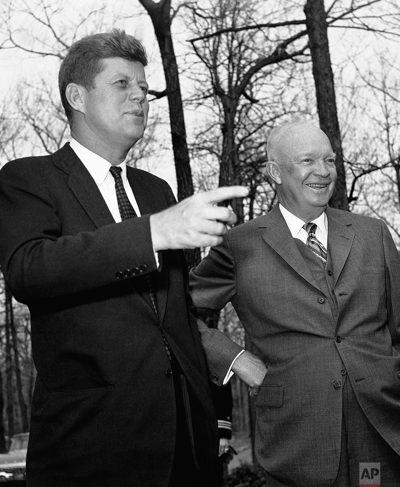  President John Kennedy points as former President Dwight Eisenhower looks out over Camp David after the two conferred on April 22, 1961 at the presidential hideaway at Thurmont, Maryland on the Cuban situation. (AP Photo) 