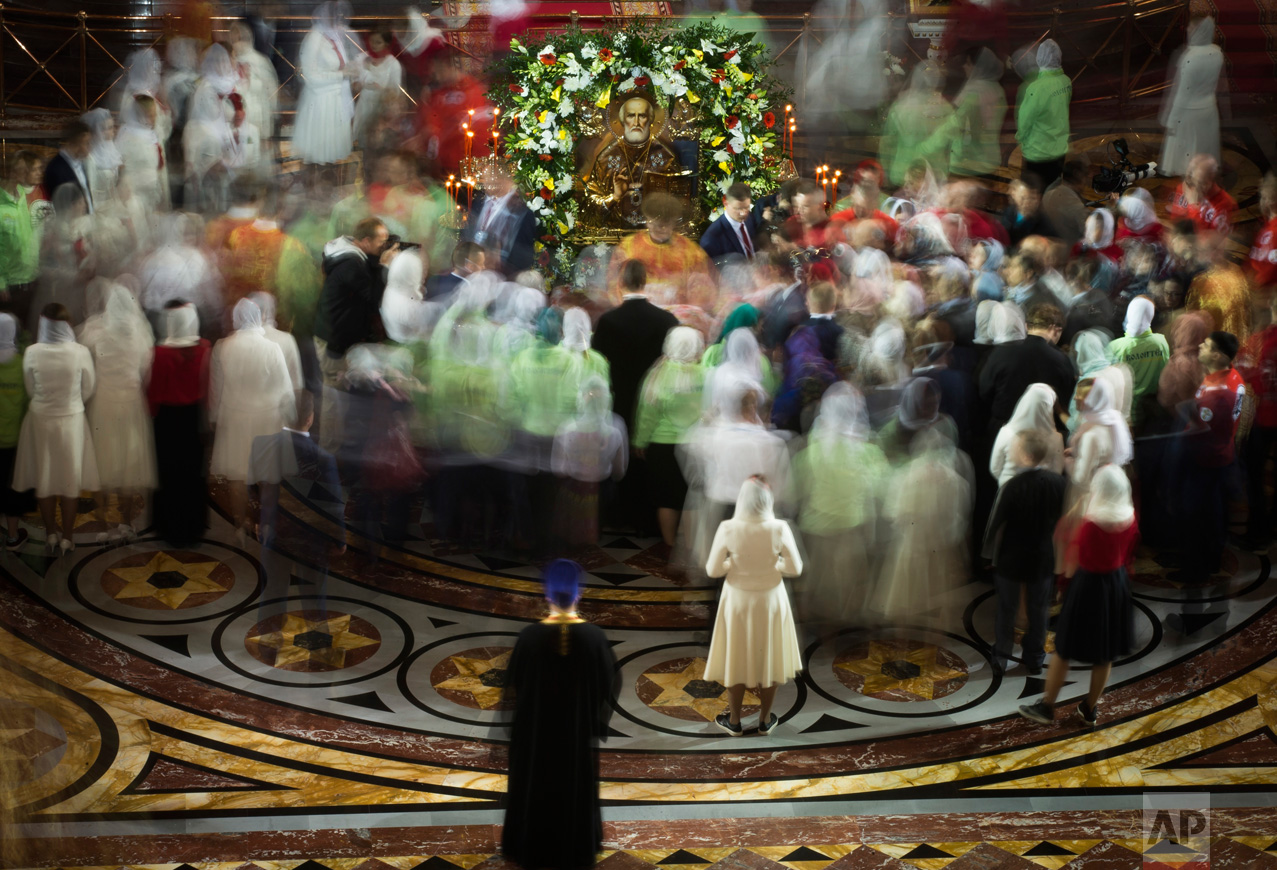 Russian Orthodox believers gather to kiss the relics of Saint Nicholas in the Christ the Savior Cathedral in Moscow, Russia, on Sunday, May 21, 2017. Relics of Saint Nicholas, one of the Russian Orthodox Church's most revered figures, arrived in Moscow on Sunday from an Italian church where they have lain for 930 years. An icon of of Saint Nicholas is in the center. (AP Photo/Alexander Zemlianichenko)
