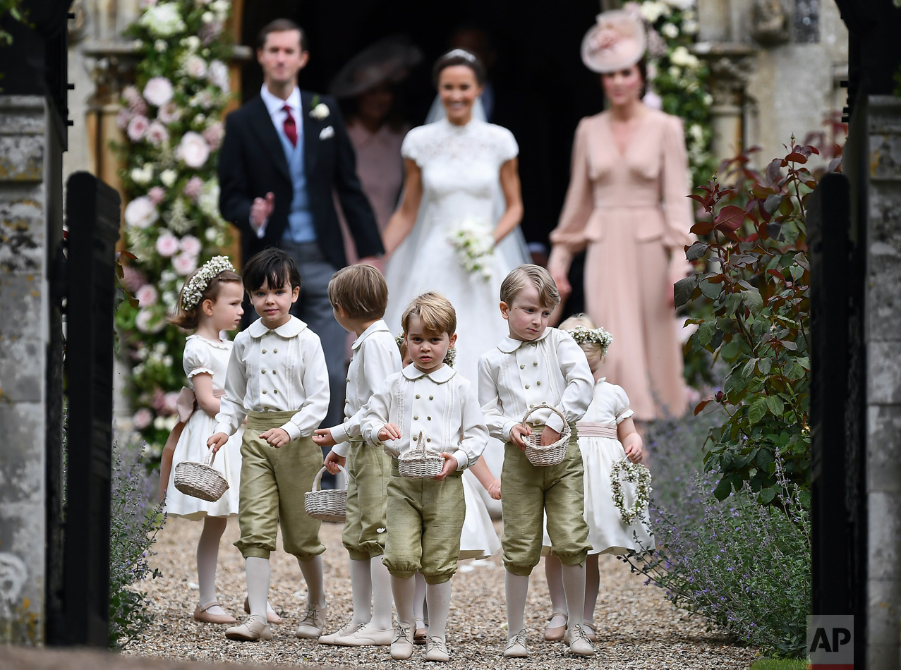  Britain's Prince George, foreground center, reacts after the wedding of his aunt, Pippa Middleton to James Matthews, at St Mark's Church in Englefield, England on Saturday, May 20, 2017. Middleton, the sister of Kate, Duchess of Cambridge, married h
