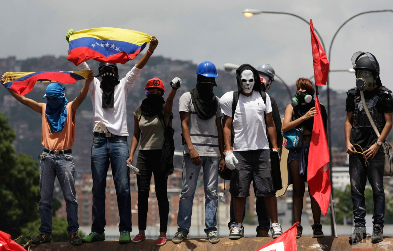  Opponents of President Nicolas Maduro gather to block a major highway in Caracas, Venezuela, Saturday, May 20, 2017. The anti-government protesters took to the streets again after weeks of unrest have left more than 40 dead. (AP Photo/Fernando Llano
