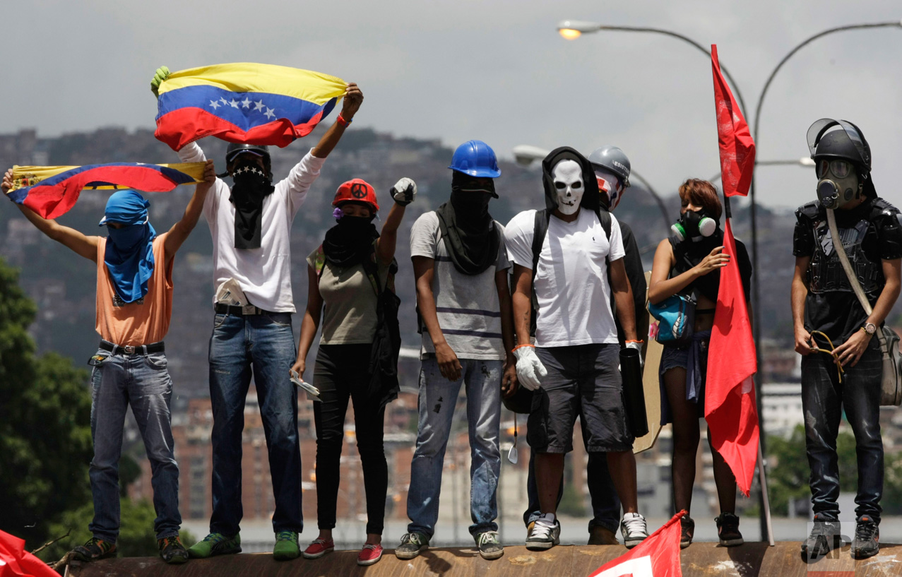 Opponents of President Nicolas Maduro gather to block a major highway in Caracas, Venezuela, Saturday, May 20, 2017. The anti-government protesters took to the streets again after weeks of unrest have left more than 40 dead. (AP Photo/Fernando Llano)