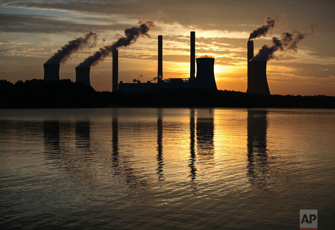 The coal-fired Plant Scherer, one of the nation's top carbon dioxide emitters, stands in the distance in Juliette, Ga., Saturday, June, 3, 2017. U.S. President Donald Trump declared Thursday he was pulling the U.S. from the landmark Paris climate agreement, striking a major blow to worldwide efforts to combat global warming and distancing the country from its closest allies abroad. (AP Photo/Branden Camp)