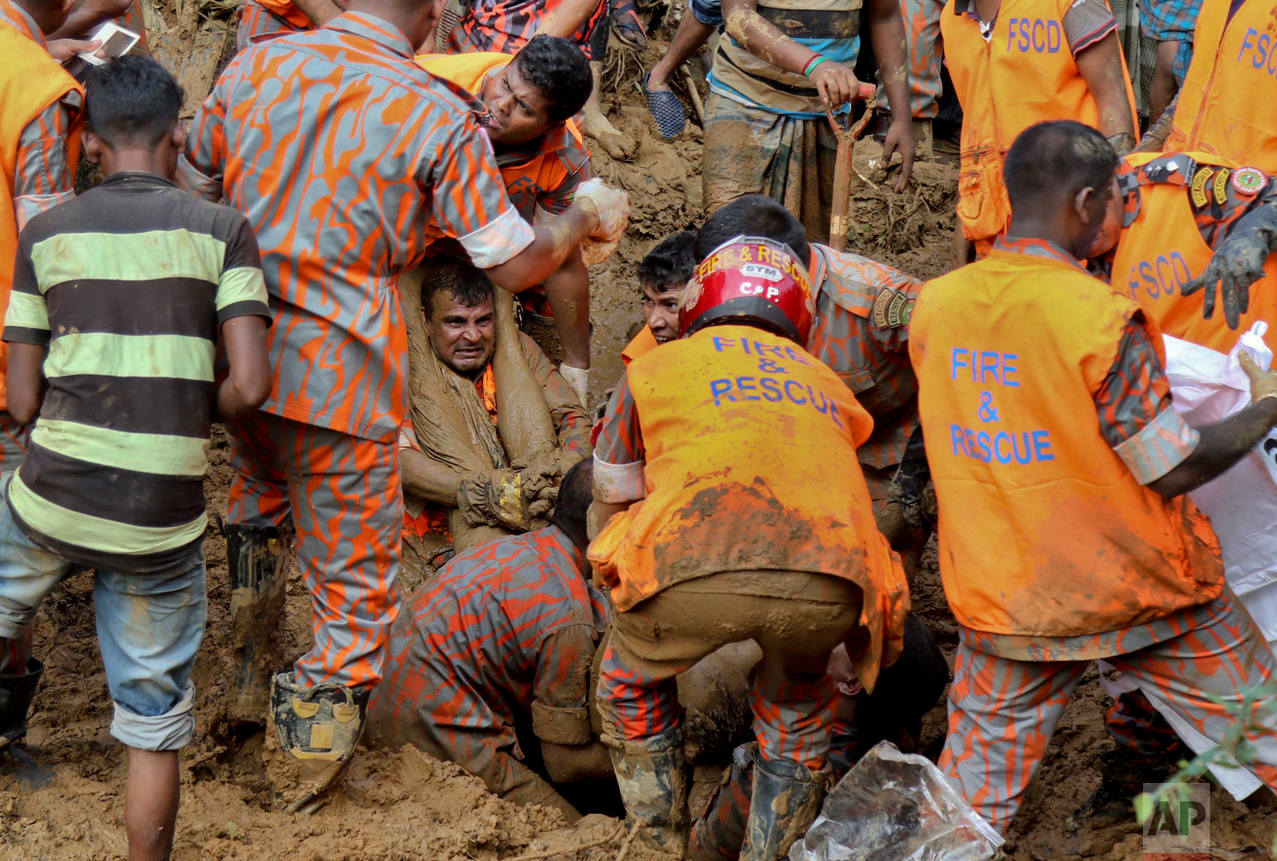Rescuers pull out the body of a victim after the previous day's massive landslide in Rangamati district, Bangladesh, Wednesday, June 14, 2017. Rescuers struggled on Wednesday to reach villages hit by massive landslides that have killed more than a hundred while also burying roads and cutting power in southeastern Bangladesh, officials said. (AP Photo)