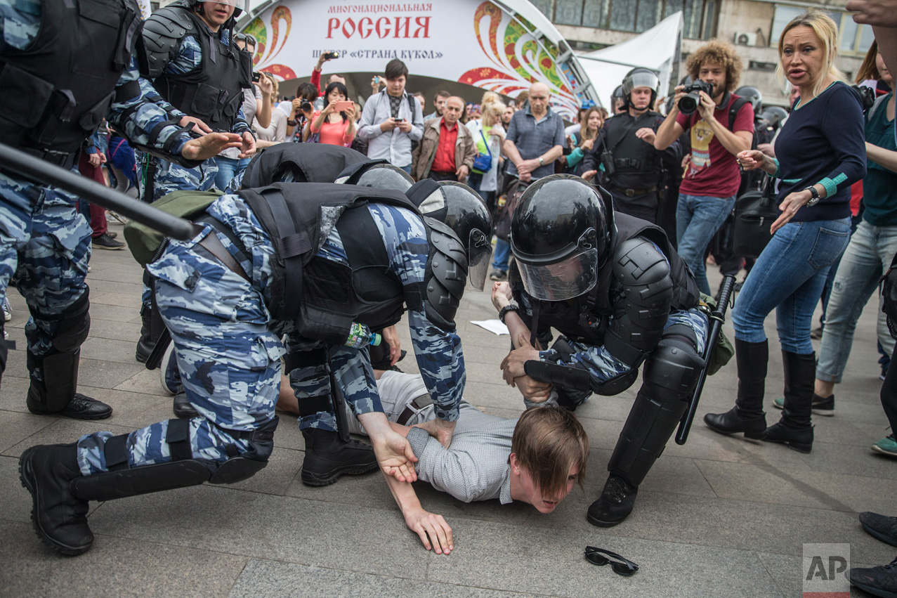 Police detain a protester In Moscow, Russia, on Monday, June 12, 2017. Demonstrators in Monday's opposition protests across Russia say they are fed up with endemic corruption among officials. The protest gatherings in cities from Far East Pacific ports to St. Petersburg were spearheaded by Alexei Navalny, the anti-corruption campaigner who has become the Kremlin's most visible opponent. (Evgeny Feldman/Pool Photo via AP)