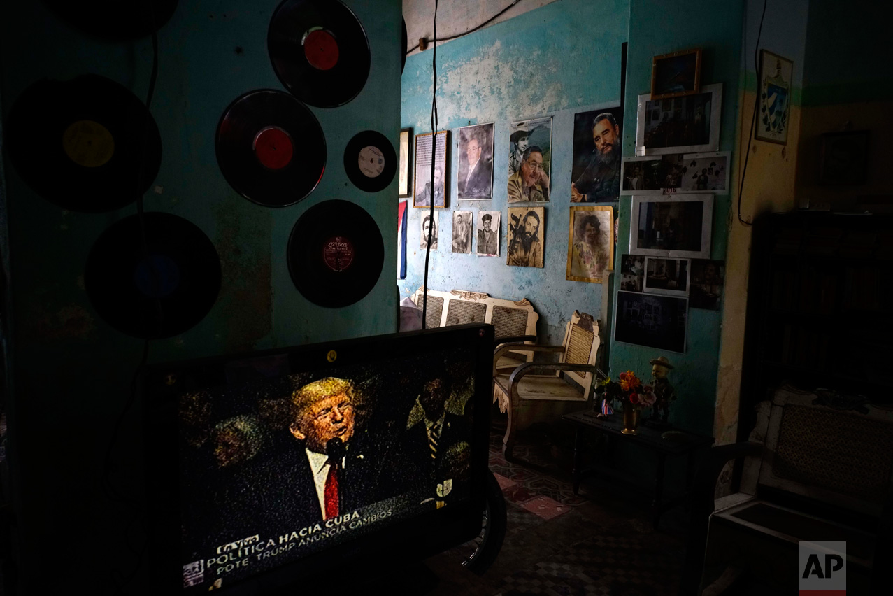  A television set shows U.S. President Donald Trump announcing his new Cuba policy, in a living room decorated with images of Cuban leaders at a house in Havana, Cuba, Friday, June 16, 2017. Trump declared he was restoring some travel and economic re