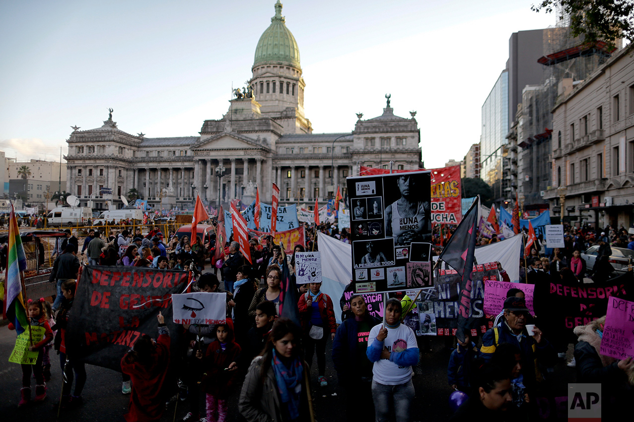  In this June 3, 2017 photo, Maira Maidana, bottom right, holds a banner with pictures of herself during a march organized by the movement "Ni Una Menos," or Not One Less,  to protest violence against women in Buenos Aires, Argentina. “With Ni Una Me