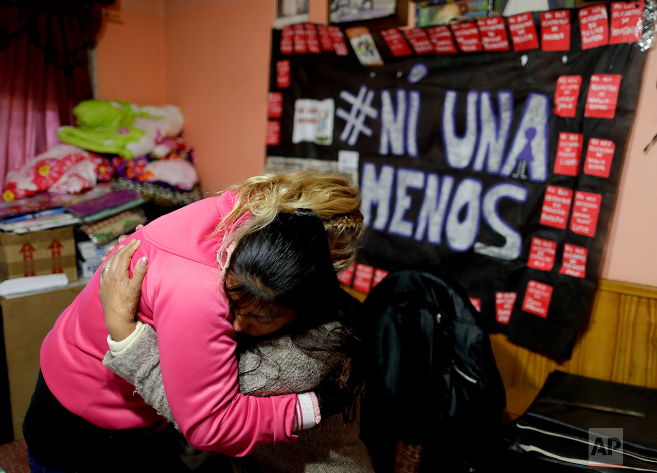  In this May 22, 2017 photo, Maira Maidana, sitting, hugs her mother Olga after breaking down in tears during an interview in Buenos Aires, Argentina. Maidana slowly had to learn to eat and walk again with the help of her mother after her partner set