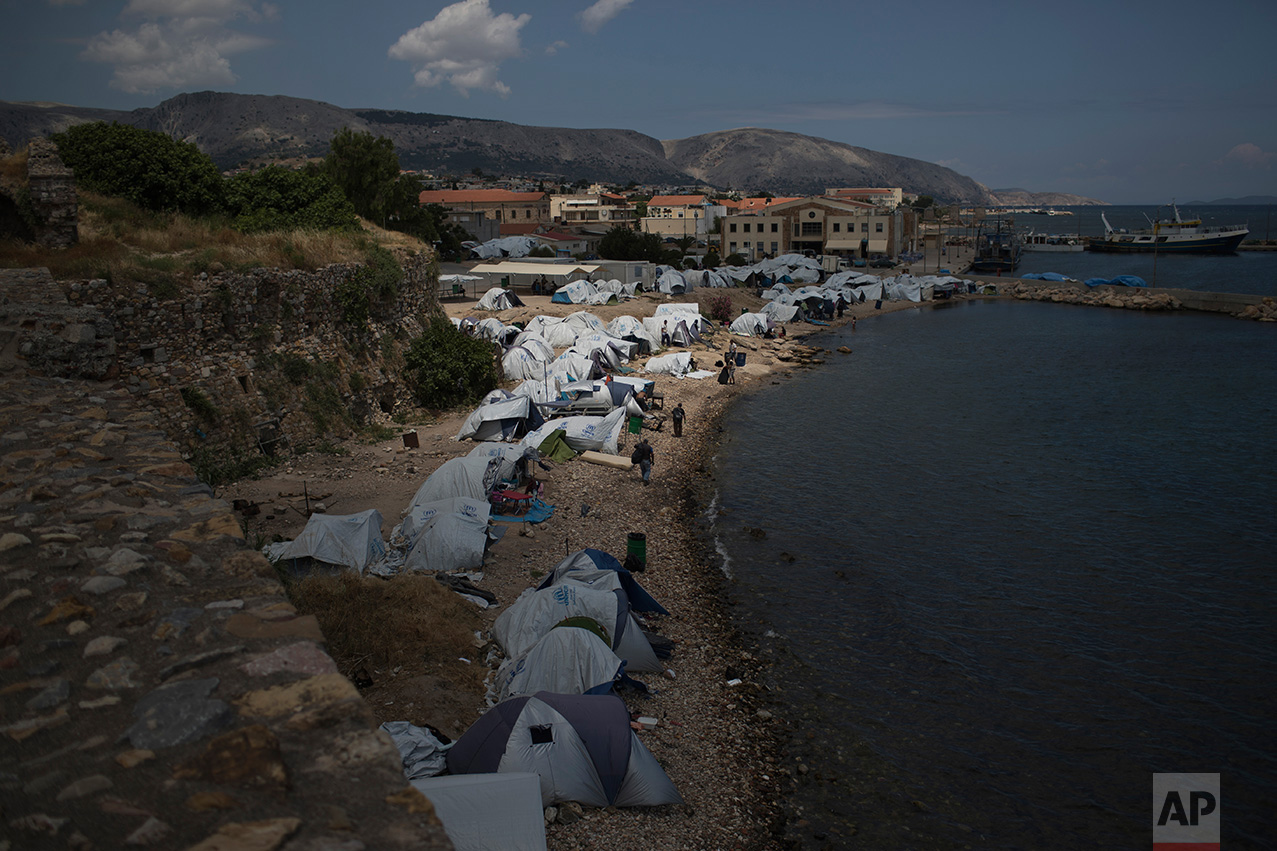  In this June 9, 2017 photo, tents that refugees and other migrants use as a temporary shelter stand on a beach near the Souda refugee camp, next to the medieval castle of Chios island, Greece.&nbsp;&nbsp;(AP Photo/Petros Giannakouris) 