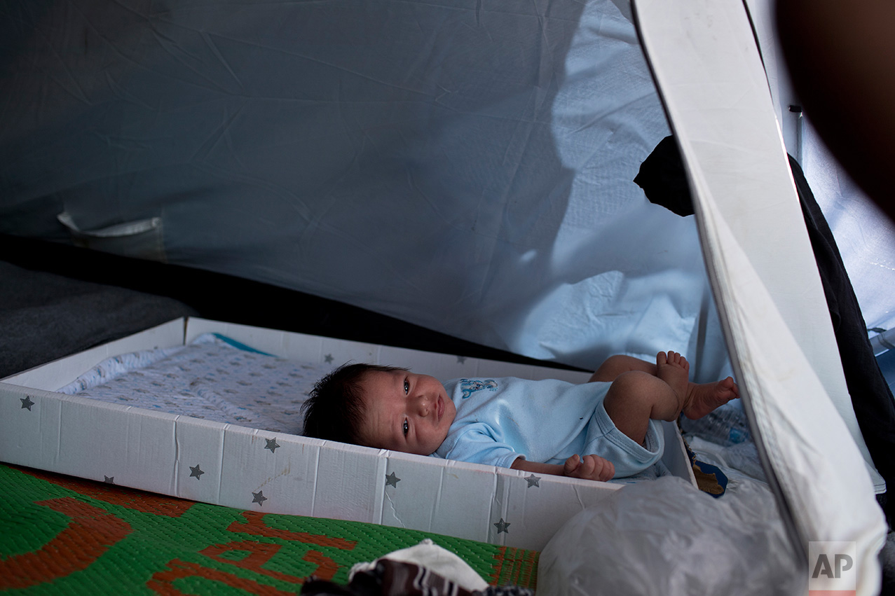  In this June 9, 2017 photo, two-week- old baby boy Mohamed Omar, who was born in Turkey, is seen inside a tent on a beach outside the Souda refugee camp on Chios island, Greece. Omar's four-member family from Palestine arrived in Greece on Sunday, J