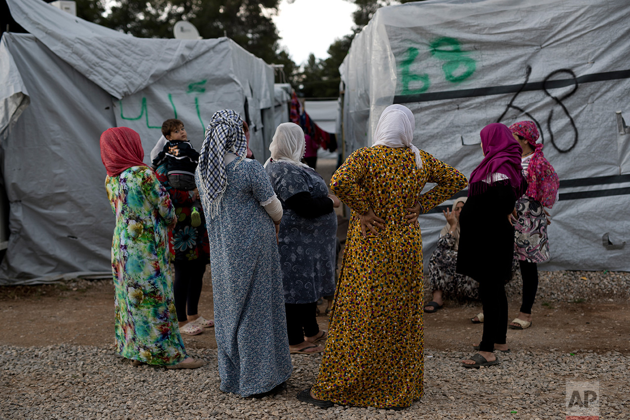  In this May 29, 2017 photo, Syrian women chat at the refugee camp of Ritsona about 86 kilometers (53 miles) north of Athens. 62258 refugees and migrants live in Greece according to the government's latest report on June 18, 2017. (AP Photo/Petros Gi