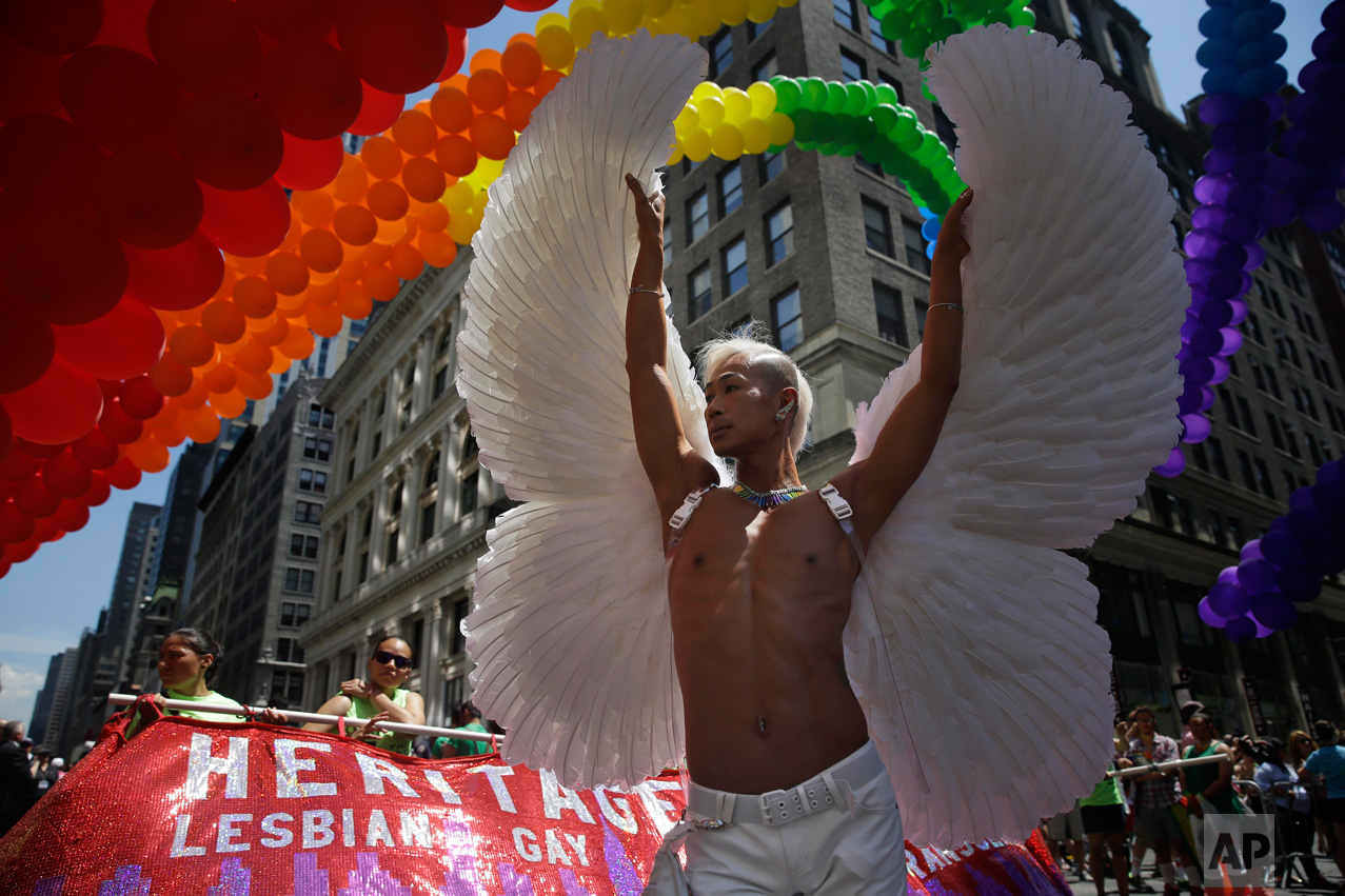  Kent Chua poses for pictures at the start of the Gay Pride Parade in New York, Sunday, June 29, 2014. (AP Photo/Seth Wenig) 