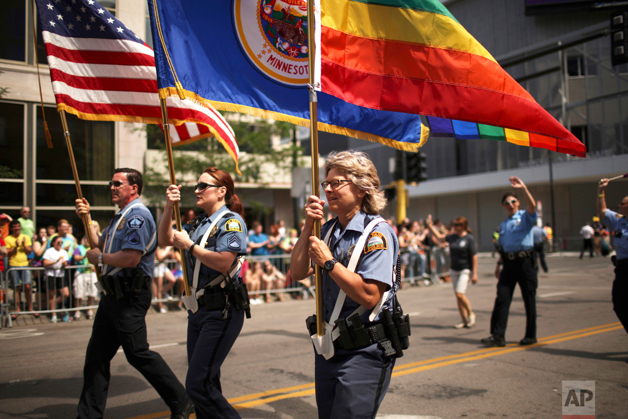  In this June 28, 2017 photo, officers from Minneapolis and St. Paul police departments lead the the Twin Cities Pride Parade in Minneapolis.   Organizers of Sunday, June 25, 2017  Twin Cities Pride Parade asked the police department to limit partici