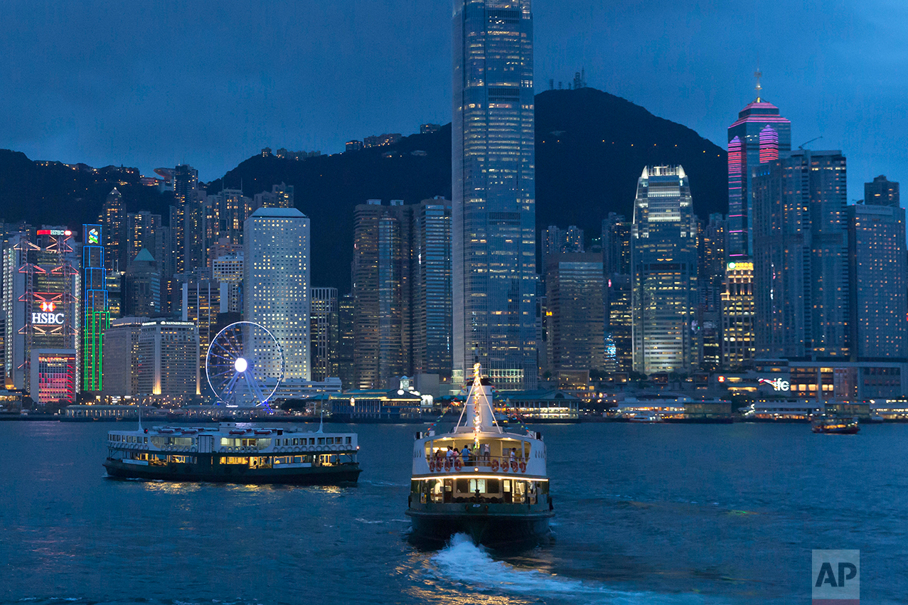 This June 20, 2017, photo, shows a general view of Victoria Peak and Central district over Victoria Harbor, in Hong Kong. (AP Photo/Kin Cheung)