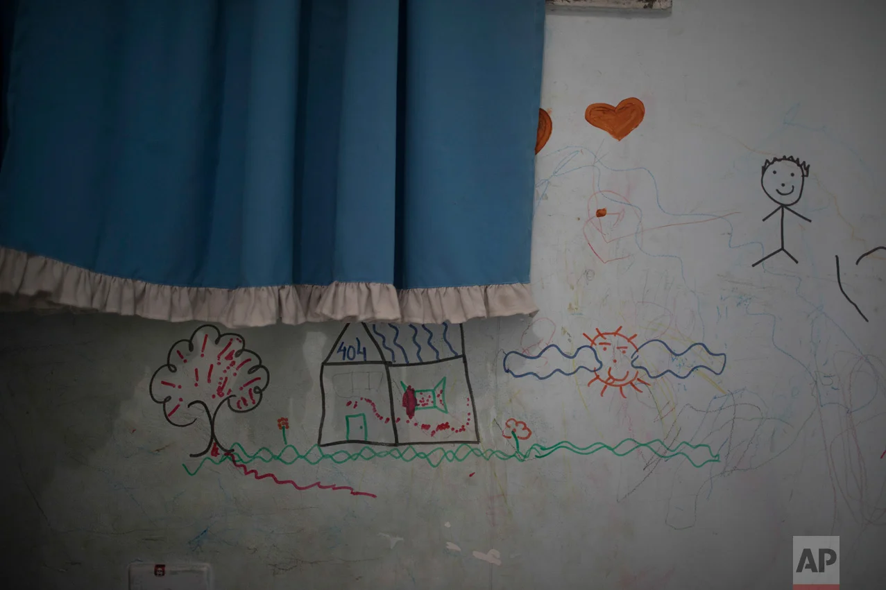 In this June 10, 2017 photo, drawings cover the wall of Isaac's room in the City of God slum of Rio de Janeiro, Brazil. (AP Photo/Leo Correa)