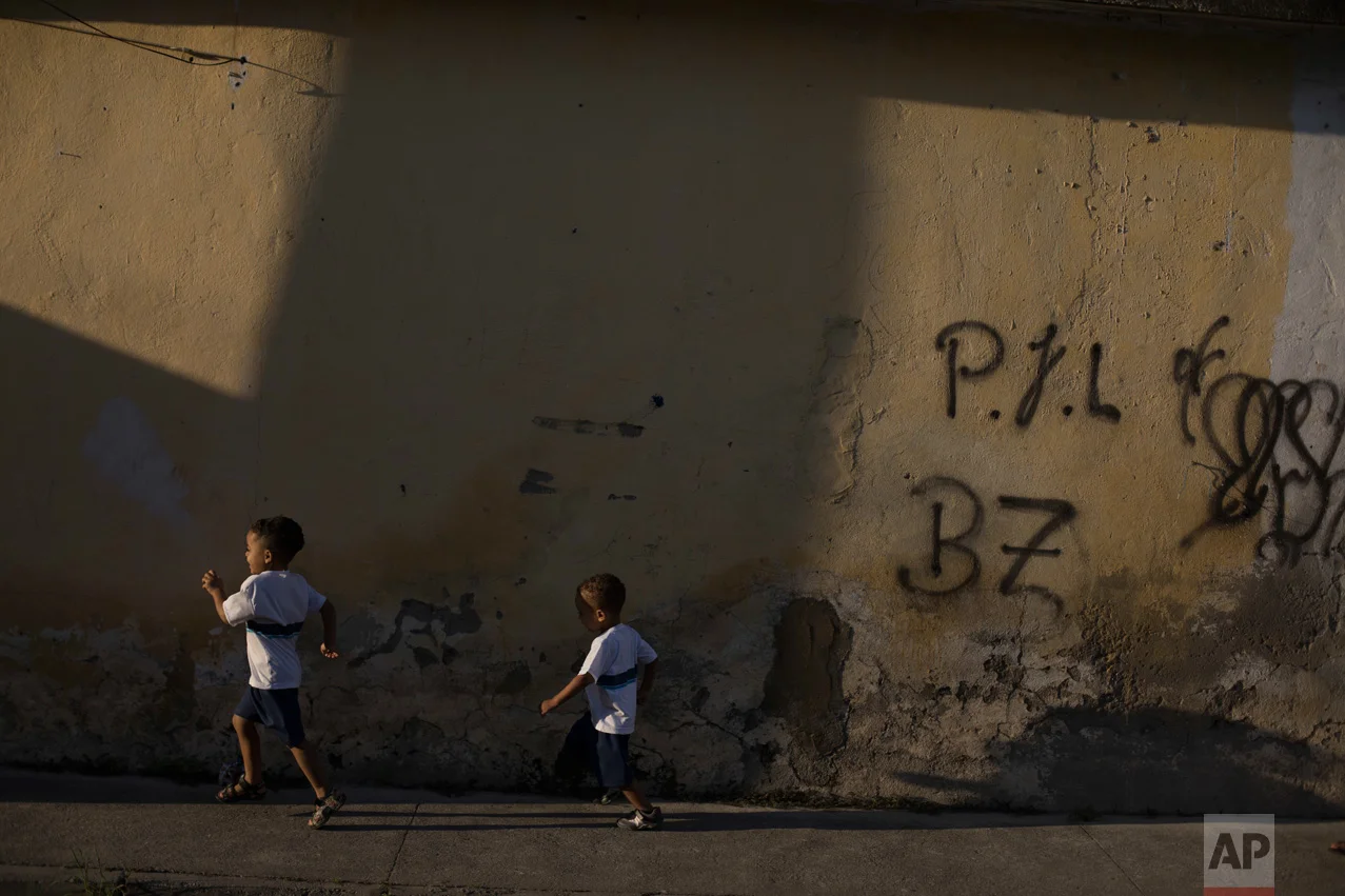 In this June 7, 2017 photo, children walk to school in the City of God slum of Rio de Janeiro, Brazil. (AP Photo/Leo Correa)