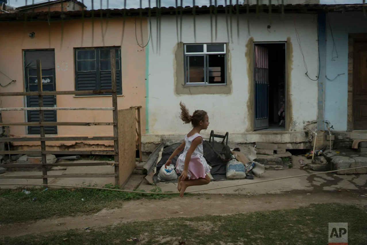 In this June 8, 2017 photo, a girl jumps rope in the neighborhood of "Cantinho do Ceu" which means in Portuguese "Heaven's corner," one of the poorest areas within the City of God slum in Rio de Janeiro, Brazil. (AP Photo/Leo Correa)