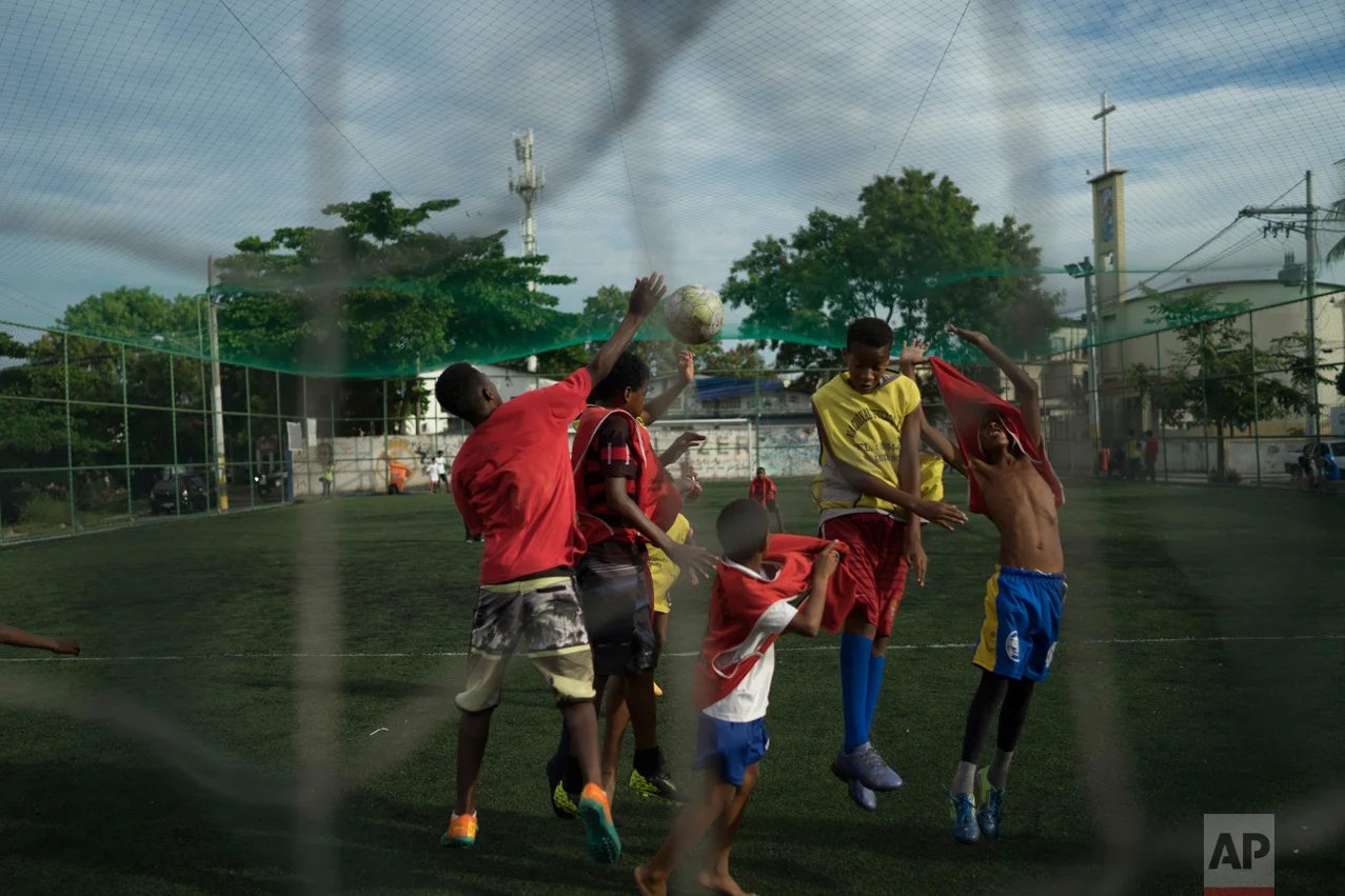 In this June 5, 2017 photo, youths play soccer in the City of God slum of Rio de Janeiro, Brazil. (AP Photo/Leo Correa)