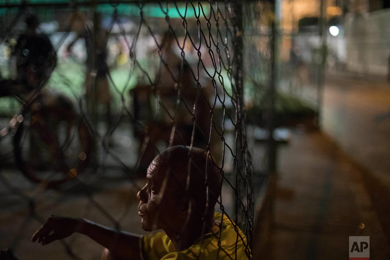 In this June 6, 2017 photo, rapper and breakdancing instructor Robson Luiz de Mendonca rests after playing basketball in the City of God slum of Rio de Janeiro, Brazil. (AP Photo/Leo Correa)