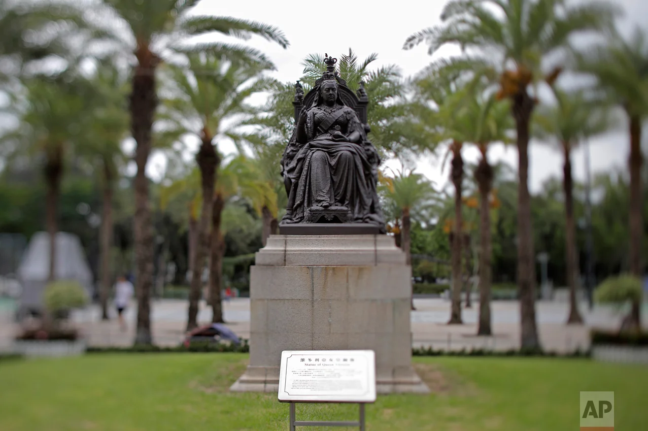 In this June 4, 2017, photo made with a tilt-shift lens, a statue of Britain's Queen Victoria is seen at Victoria Park in Hong Kong. The park near the Causeway Bay downtown shopping district has been the rallying point for the annual pro-democracy march and vigil to remember victims of the bloody 1989 military crackdown on protesters in Beijing's Tiananmen Square. Two decades since Beijing took control of Hong Kong, China's rising influence – and Britain's waning profile – are impossible to ignore. (AP Photo/Vincent Yu)