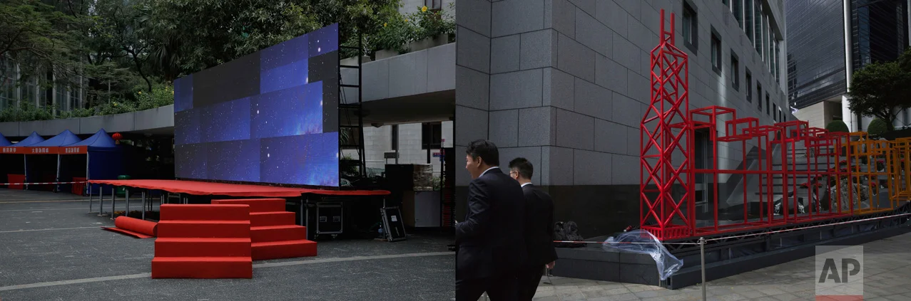 In this combination of photos, left: Red carpeted steps lead up to a stage with screens displaying an image of the universe, in Hong Kong, Thursday, June 22, 2017; and right: A red sculpture is displayed outside the Bank of China headquarters in Hong Kong to celebrate the anniversary of Hong Kong handover to China, Friday, June 23, 2017. (AP Photo/Kin Cheung)
