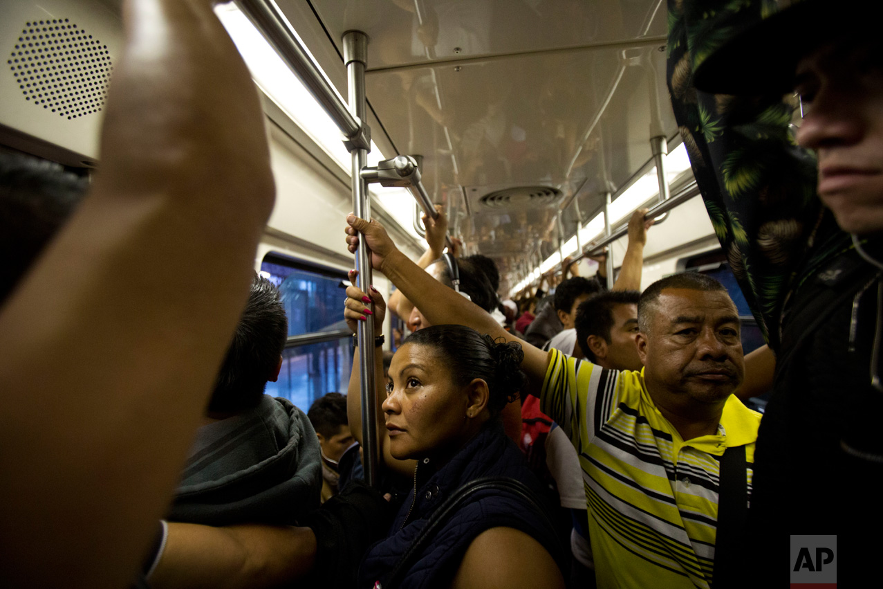 In this June 27, 2017 photo, Honduran refugee Laura Maria Cruz Martinez rides the subway during a 75-minute commute home following her 10-hour work day, in Mexico City. (AP Photo/Rebecca Blackwell)