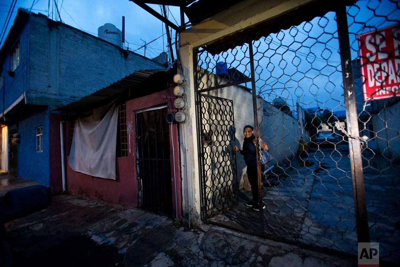 In this June 27, 2017 photo, Honduran refugee Laura Maria Cruz Martinez, 40, arrives home from work to the building where she, her three children and her niece share a two-bedroom apartment with a Salvadoran refugee and her daughter, in the Iztapalapa district of Mexico City. (AP Photo/Rebecca Blackwell)