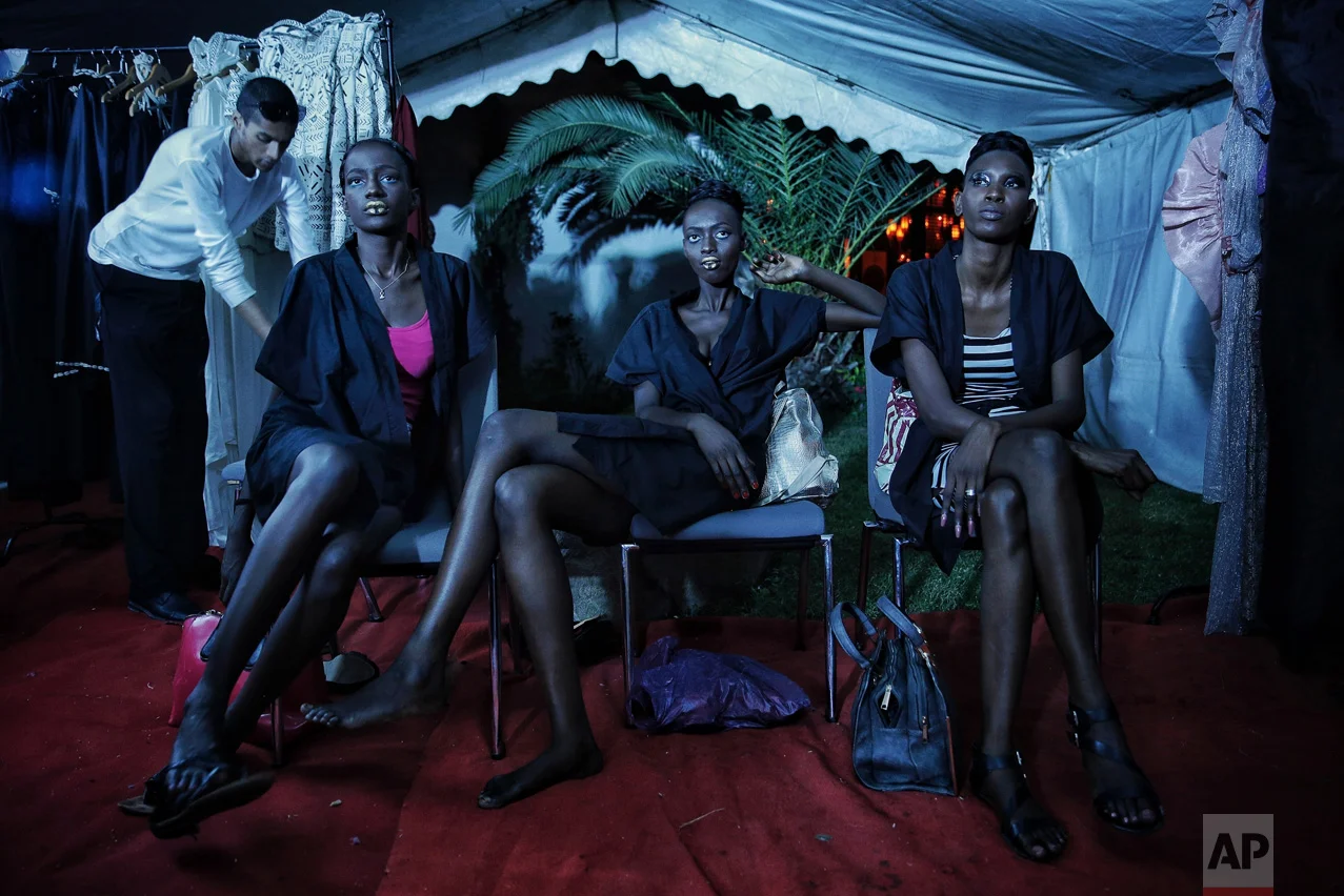 Models sit backstage during Dakar Fashion Week in the Senegalese capital, Friday June 30, 2017. (AP Photo/Finbarr O'Reilly)