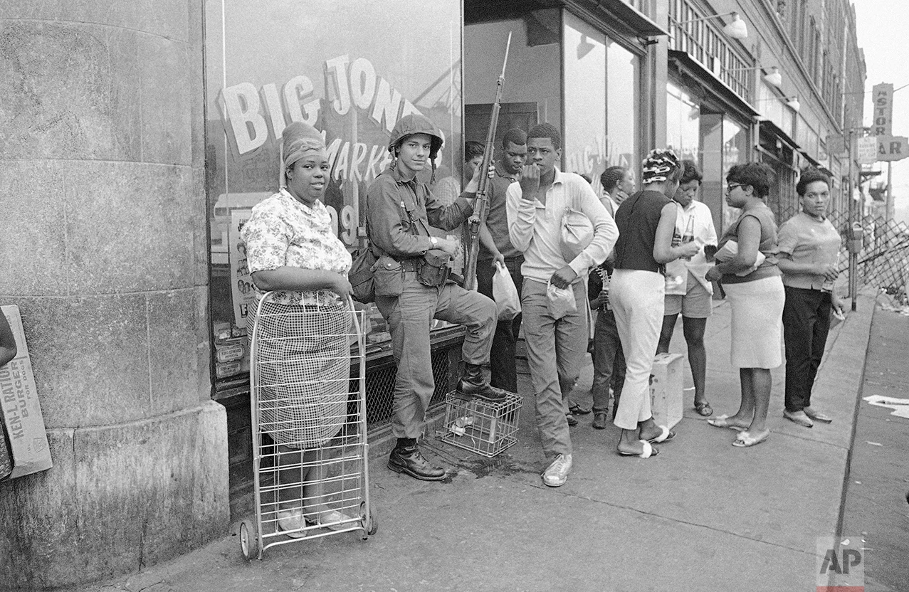 Michigan National Guardsmen relax for the first time since last Sunday when they were brought into Detroit to help put down widespread rioting, July 27, 1967. It was calm in the area on Wednesday night and after four days of violence that swelled into one of the costliest riots in the nation's history. (AP Photo)