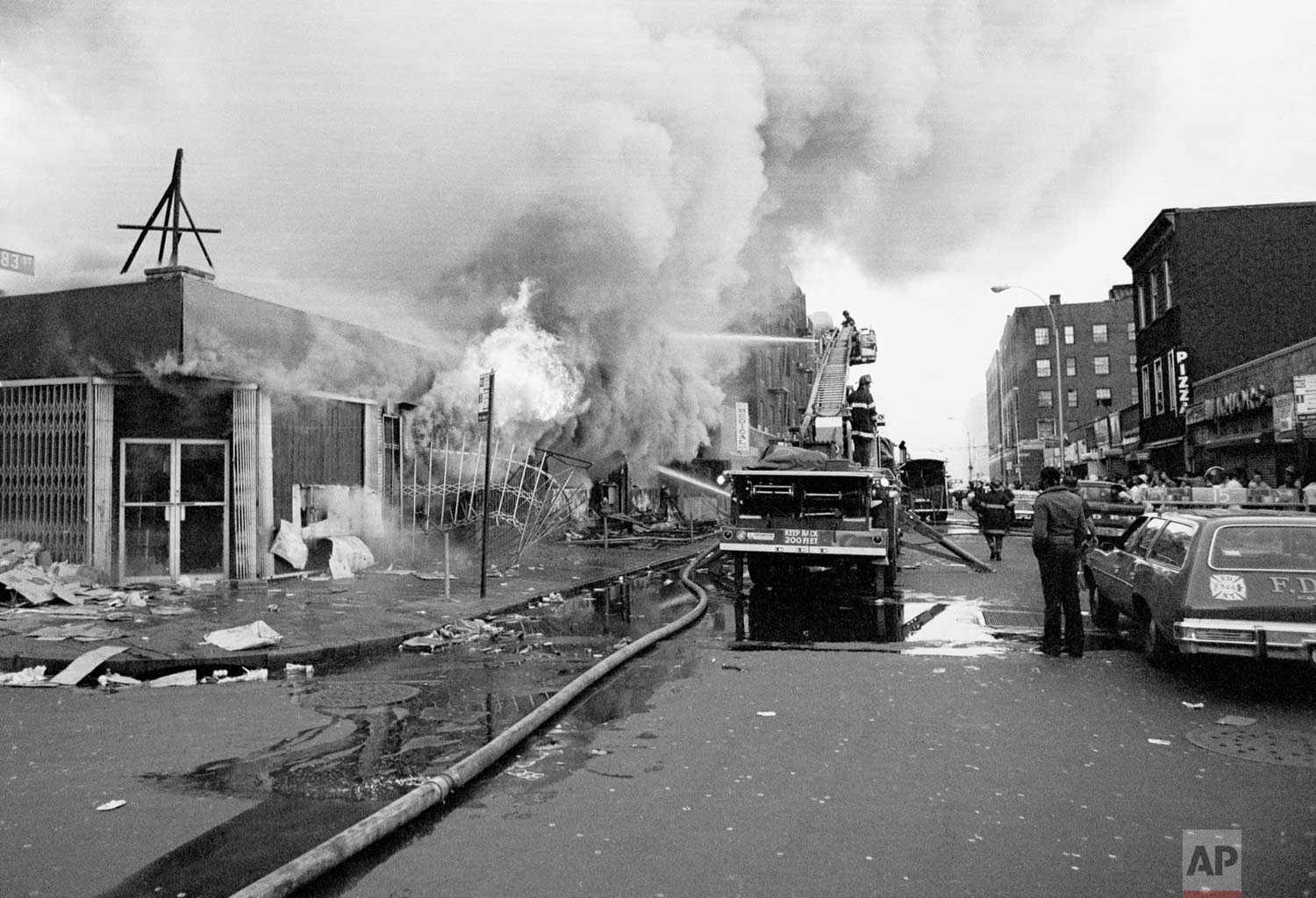  Firemen battle flames at a store in the Bronx borough of New York, one of many fires that broke out during the massive power failure that crippled the city for more than 24 hours, seen July 14, 1977. Firemen answered 1,500 alarms, 400 of which were 