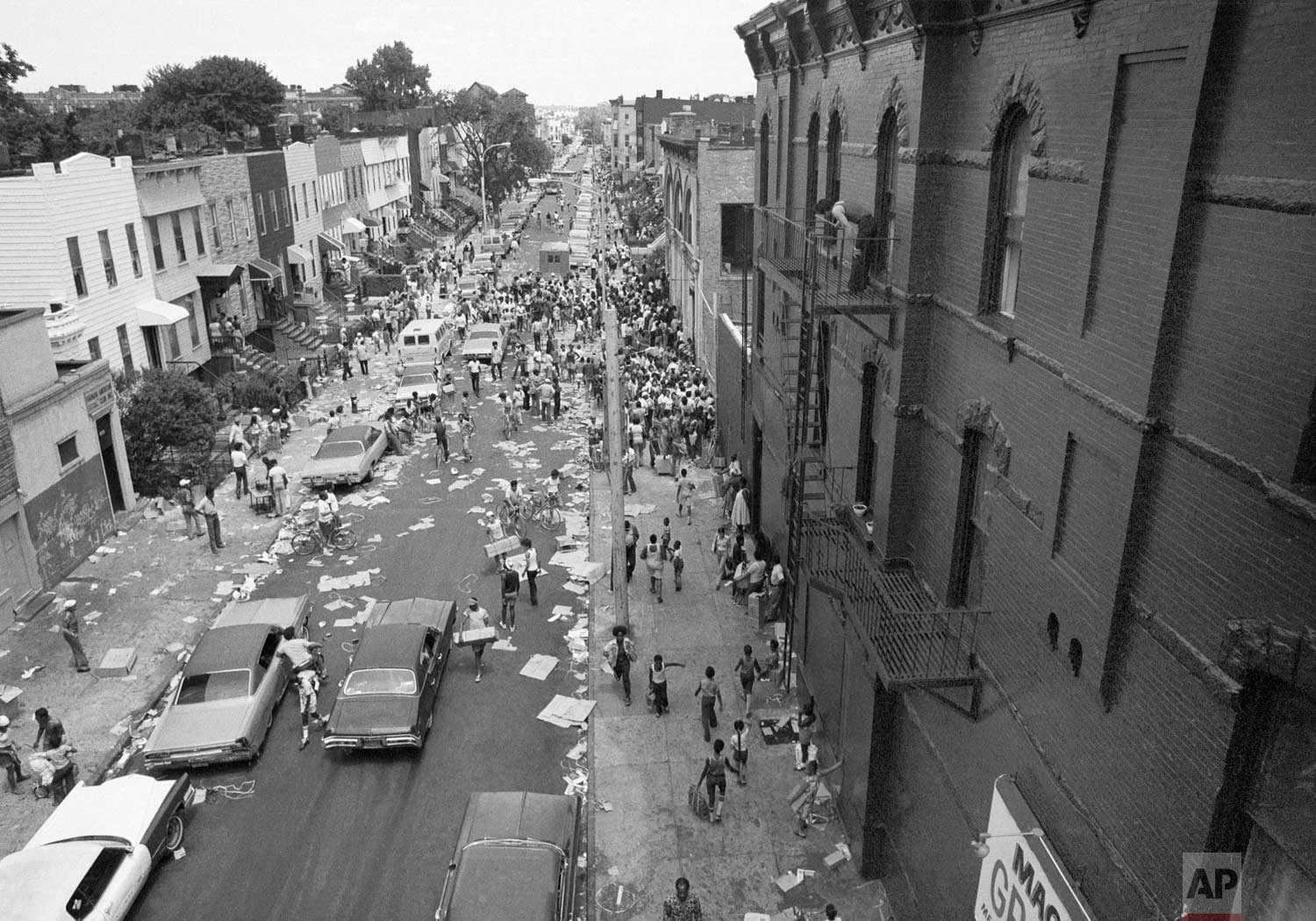  A street in the Bedford-Stuyvesant section of Brooklyn is full of people and debris, July 14, 1977 following last night's massive blackout in New York City. (AP Photo) 