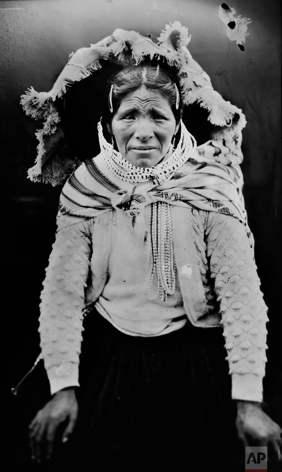 In this June 13, 2017 photo, Sebastiana Jara poses for a portrait in the Sinakara Valley, in Peru's Cusco region, during the Qoyllur Rit’i festival, translated from the Quechua language as Snow Star. Sebastiana sells handicrafts and typical fabrics from Cusco region at the festival. (AP Photo/Rodrigo Abd)