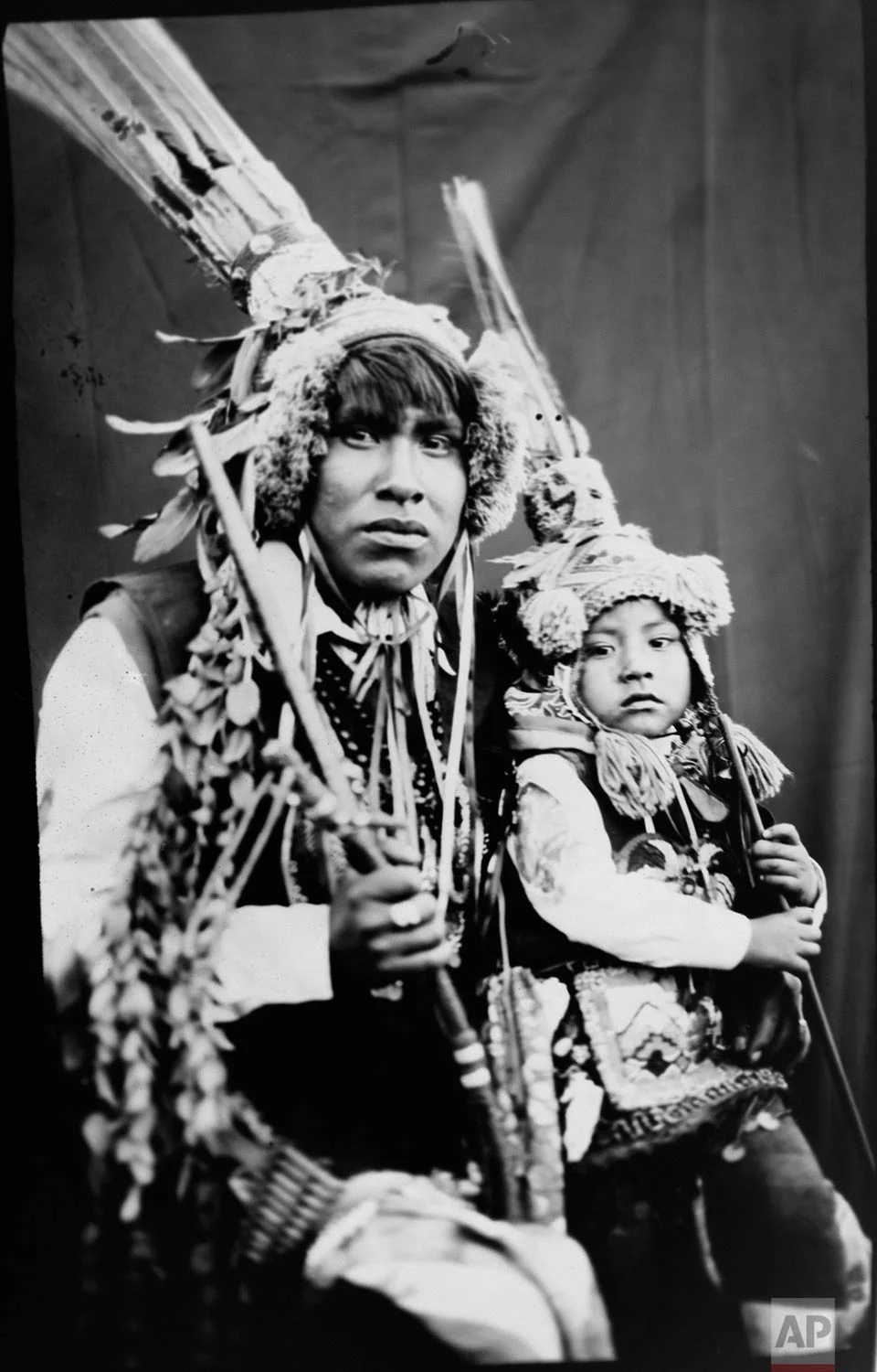 In this June 12, 2017 photo, Rudy Espiriya and his three-year-old son Dayiro Tahuara, pose for a portrait in the Sinakara Valley, in Peru's Cusco region, during the Qoyllur Rit’i festival, translated from the Quechua language as Snow Star. Rudy and Dayiro perform a dance called Paapuri Guayri as part of the Paucartambo nation. (AP Photo/Rodrigo Abd)