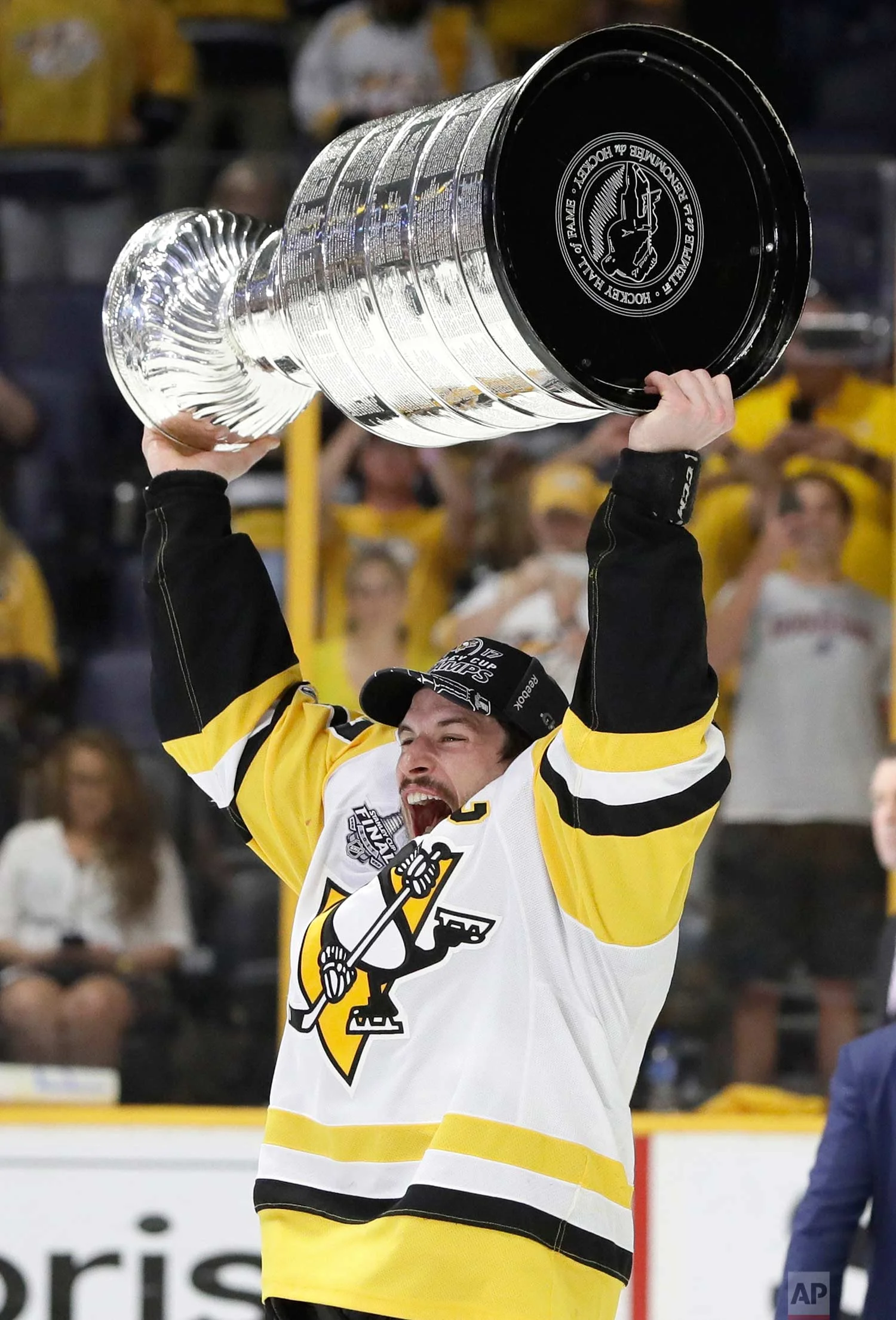 Pittsburgh Penguins' Sidney Crosby (87) celebrates with the Stanley Cup after defeating the Nashville Predators in Game 6 of the NHL hockey Stanley Cup Final, Sunday, June 11, 2017, in Nashville, Tenn. (AP Photo/Mark Humphrey)