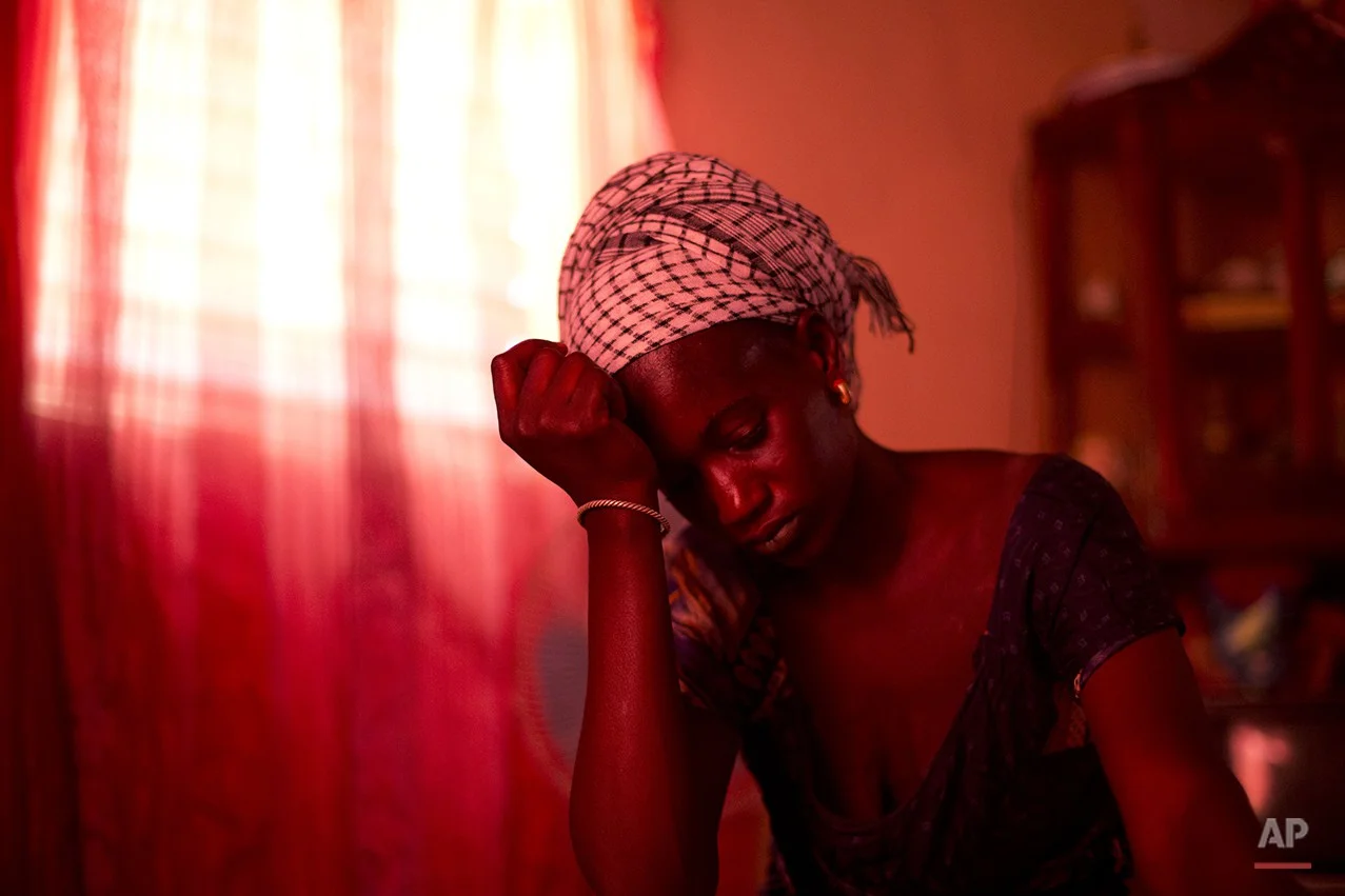  In this Oct. 10, 2013 photo, Aida Diallo, whose ten-year-old son Bamba was killed when a fire struck the Dakar shack where he was sleeping along with other Quranic students, sits in her one-room home in the village of Ndame, Senegal. Bamba's older b