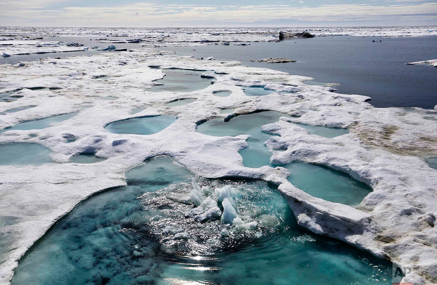 Ice is broken up by the passing of the Finnish icebreaker MSV Nordica as it sails through the Beaufort Sea off the coast of Alaska while traversing the Arctic's Northwest Passage, Sunday, July 16, 2017. The region has become a magnet for nations wanting to exploit the Arctic’s rich oil reserves and other natural resources and for scientists seeking to understand global warming and its impacts on the sea and wildlife. (AP Photo/David Goldman)