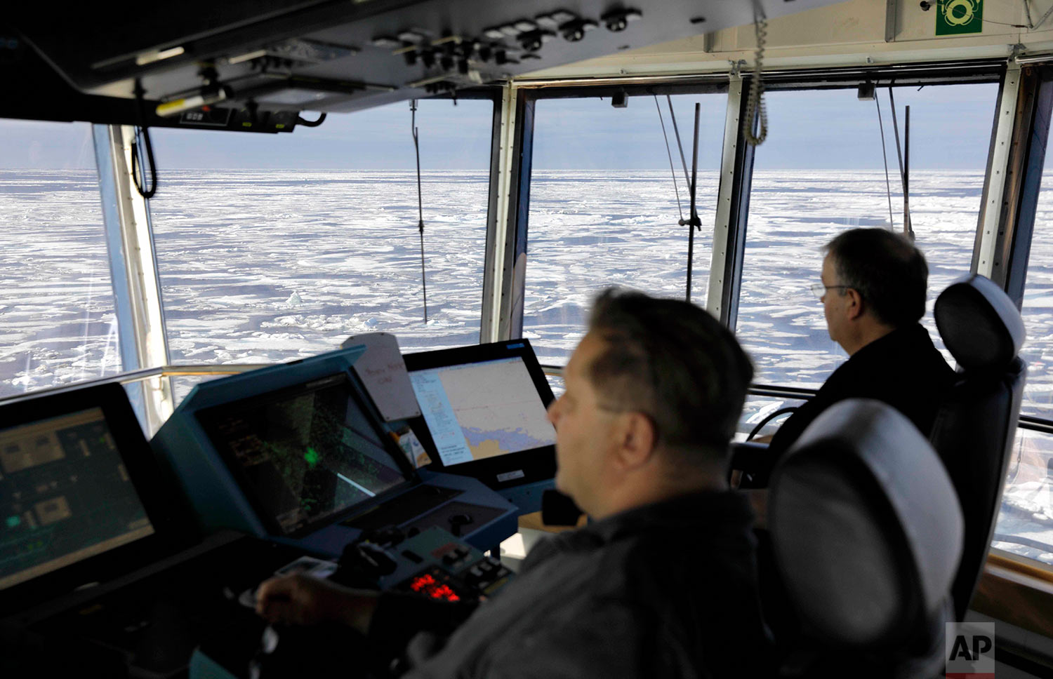  Master Mariner Jyri Viljanen, left, captain of the Finnish icebreaker MSV Nordica and Chief Officer Harri Venalainen, navigate from the bridge through ice floating on the Chukchi Sea off the coast of Alaska while traversing the Arctic's Northwest Pa