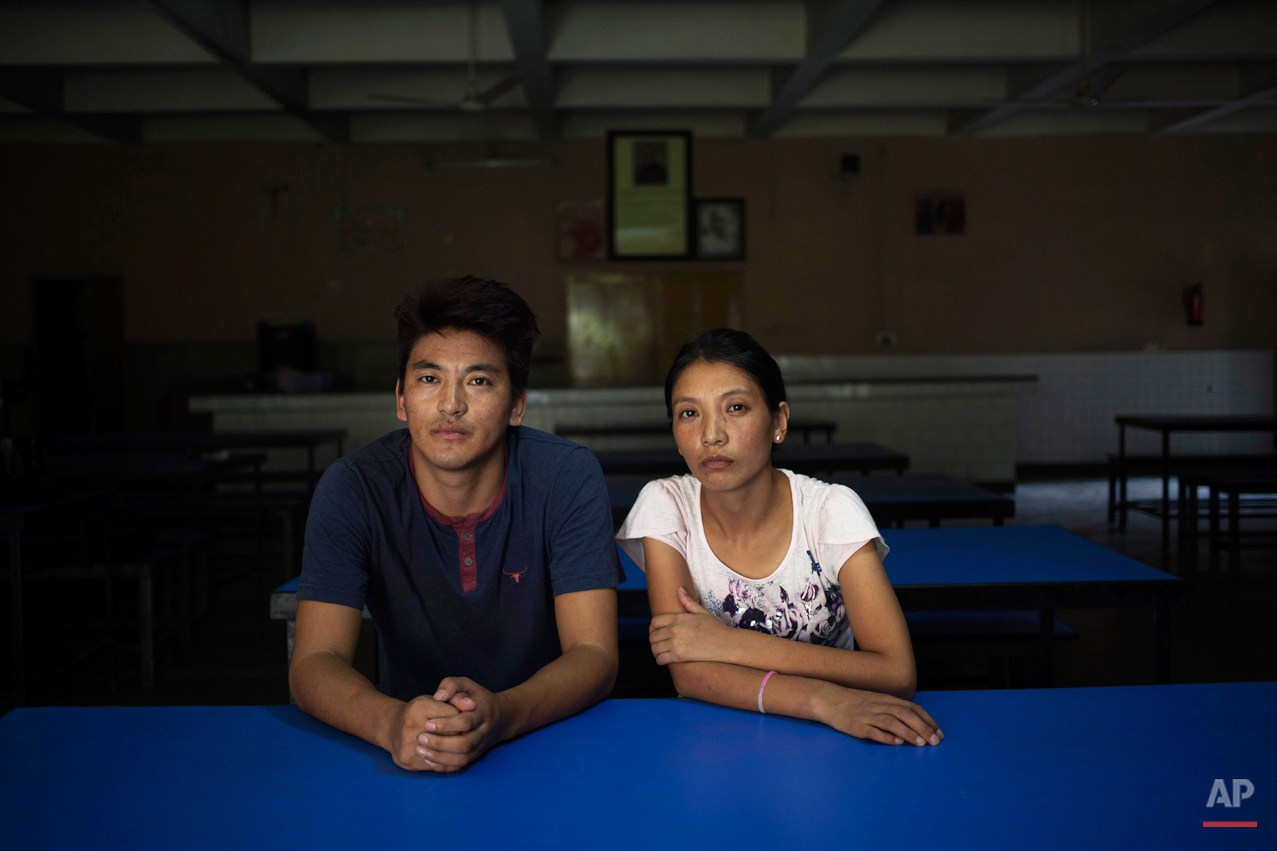  In this Monday, Aug. 18, 2014 photo, Gyalsten, 26, and his sister Kyipa pose in the dining hall of the Tibetan Youth Hostel in New Delhi, India. The duo escaped into India in 2006. Gyaltsen was given the responsibility of taking care of his younger 