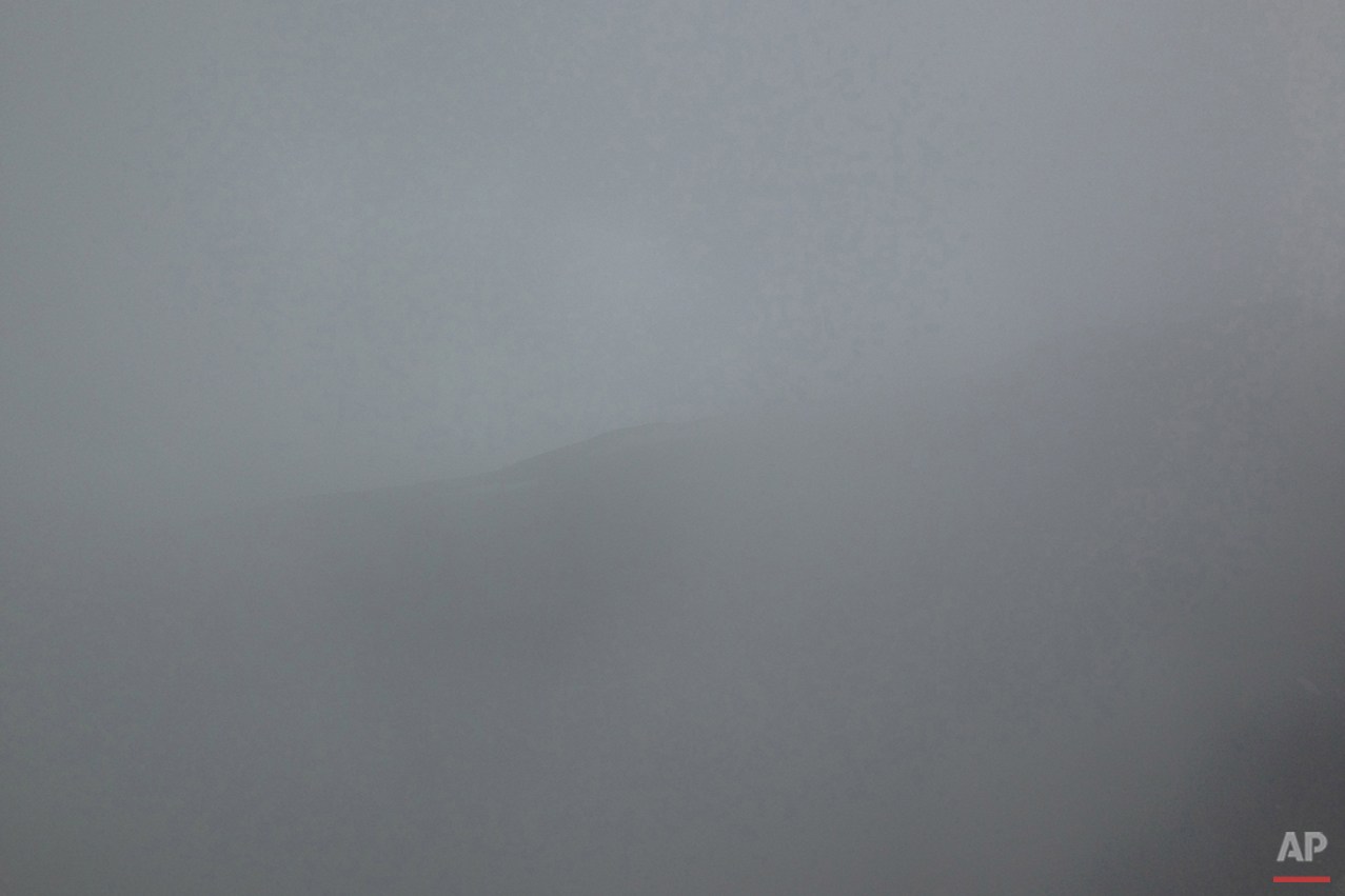  This Monday, June 30, 2014 photo shows Zoji La range seen through thick mist in Indian-Kashmir, India. Many Tibetans say that being in the mountains make them miss their homeland. (AP Photo/Tsering Topgyal) 