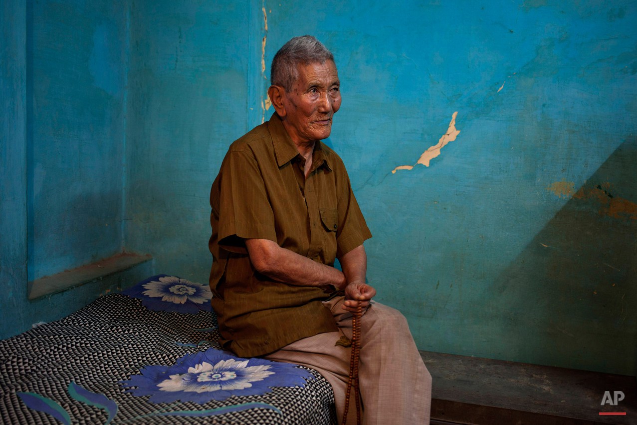  In this Wednesday, Oct. 15, 2014 photo, Kalsang Wangdue, 85, sits on a bed in his room in New Delhi, India. Wangdue says his father was a tax collector back in Tibet and he lived a good life. He escaped into India in 1959 leaving behind his wife and