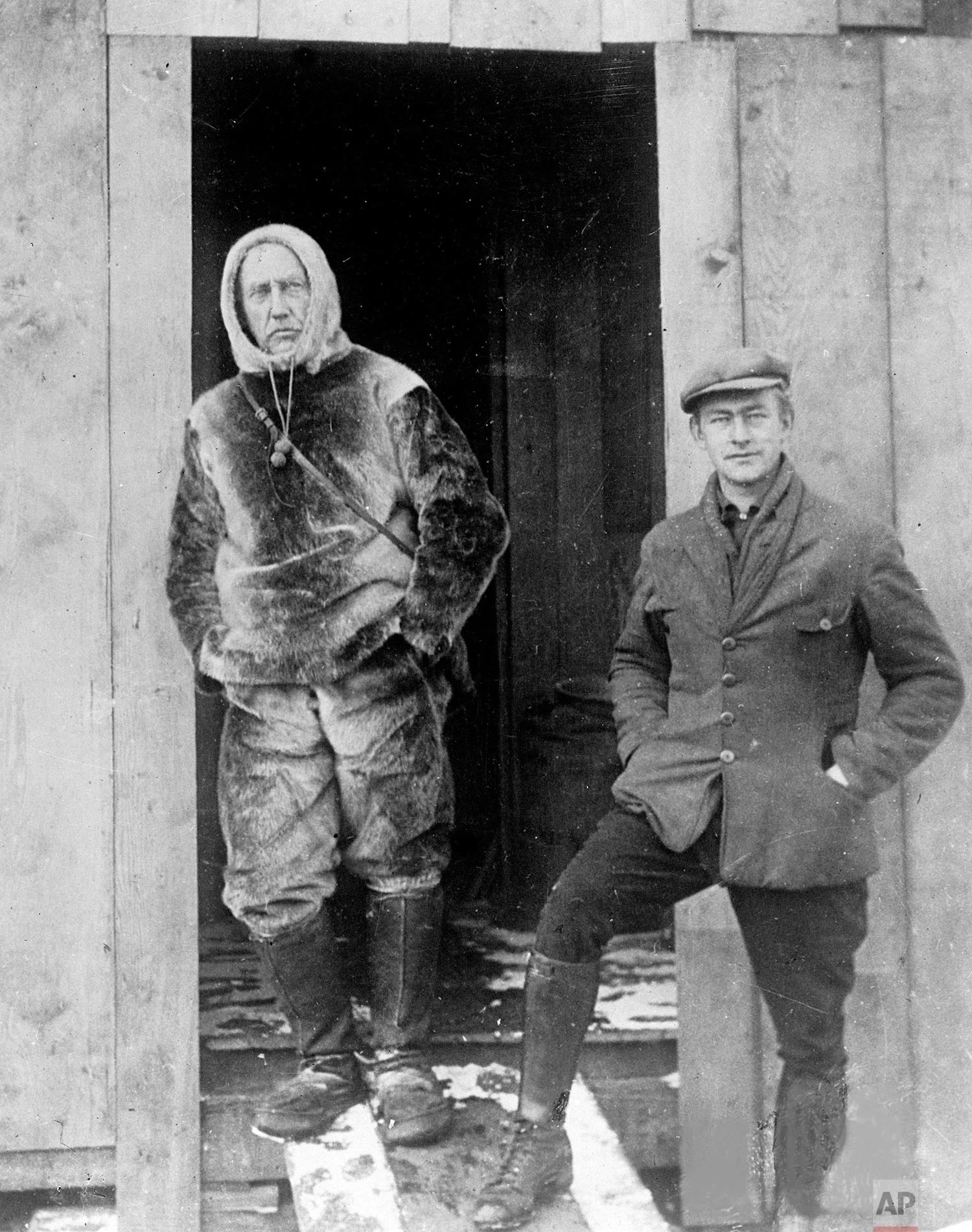 Norwegian explorer Roald Amundsen, left, stands with Lieutenant Undahl, who is his pilot in the attempt to fly over the North Pole, at the doorway to his hut on the Arctic ice in 1926. In 1911 Amundsen beat Captain Robert Scott to be the first man to reach the South Pole. (AP Photo)