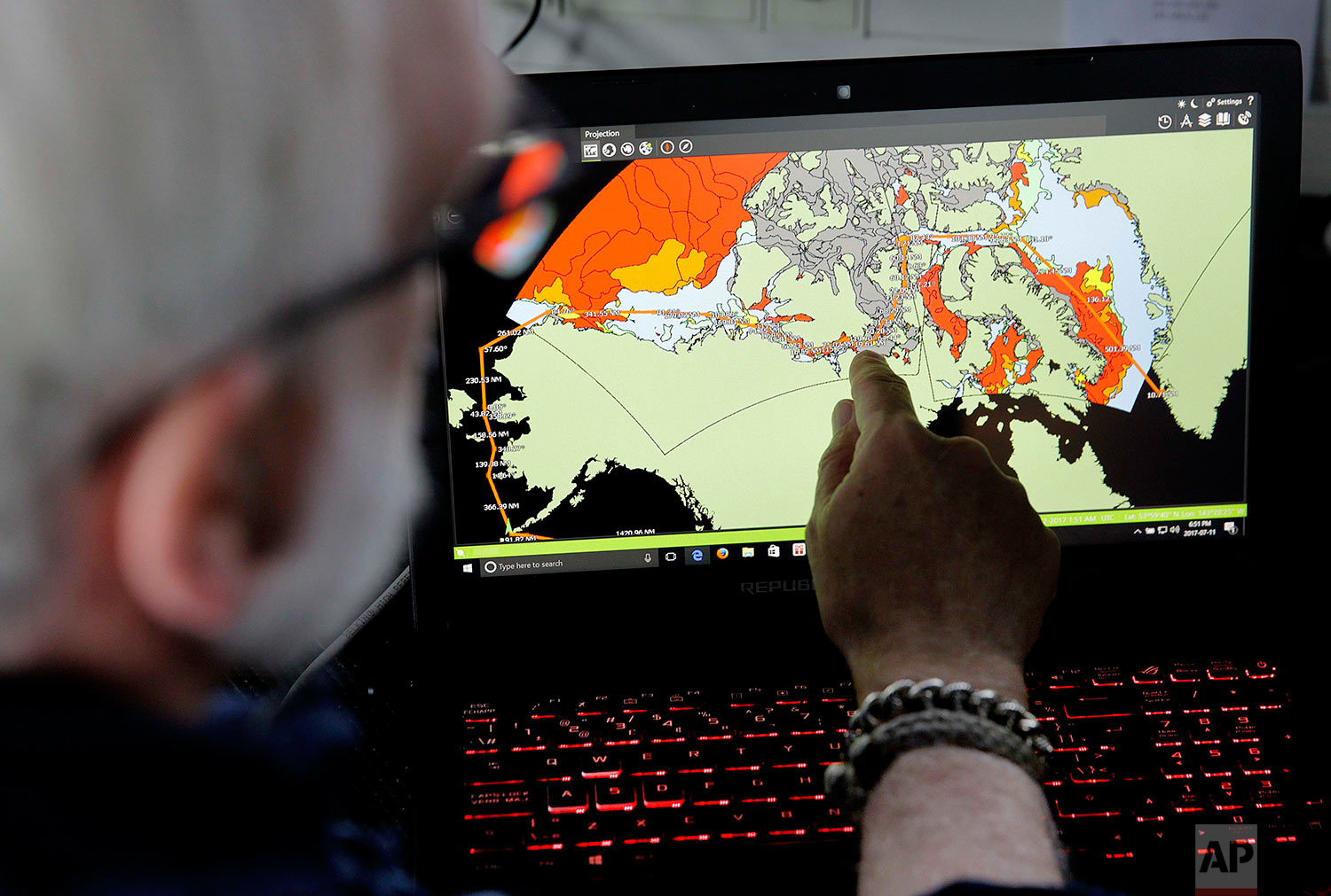  Canadian ice navigator, David "Duke" Snider shows the route the Finnish icebreaker MSV Nordica will navigate on a map of current sea ice conditions as the ship sails north in the Bering Sea Tuesday, July 11, 2017. A group of international researcher