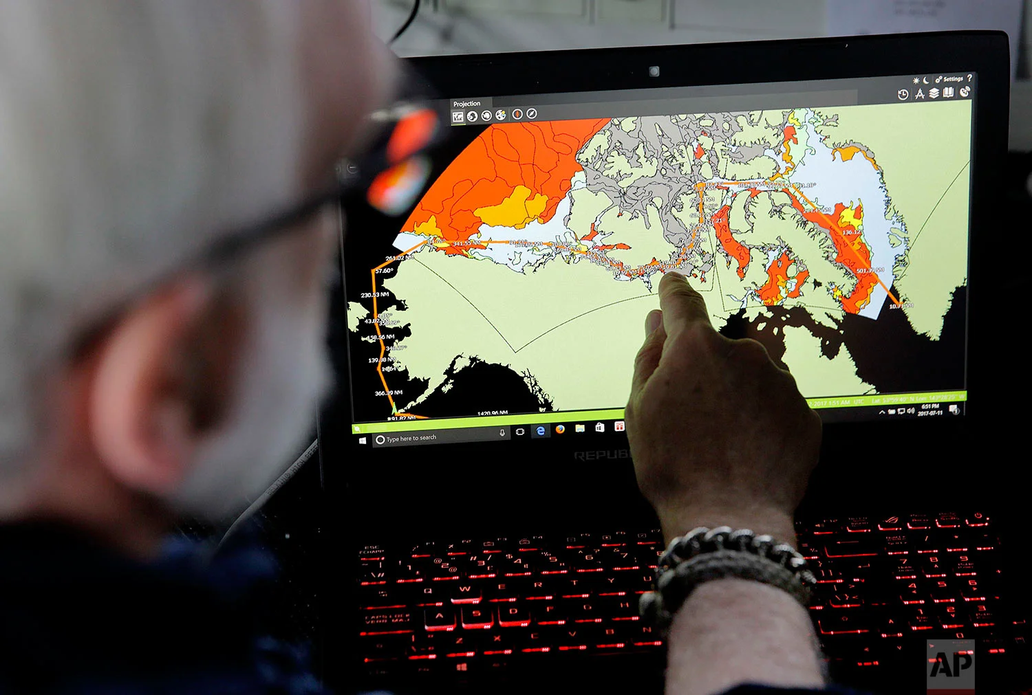 Canadian ice navigator, David "Duke" Snider shows the route the Finnish icebreaker MSV Nordica will navigate on a map of current sea ice conditions as the ship sails north in the Bering Sea Tuesday, July 11, 2017. A group of international researchers is sailing into the Arctic Sea aboard the Finnish icebreaker to traverse the Northwest Passage and record the environmental and social changes that are taking place in one of the most forbidding corners of the world. (AP Photo/David Goldman)