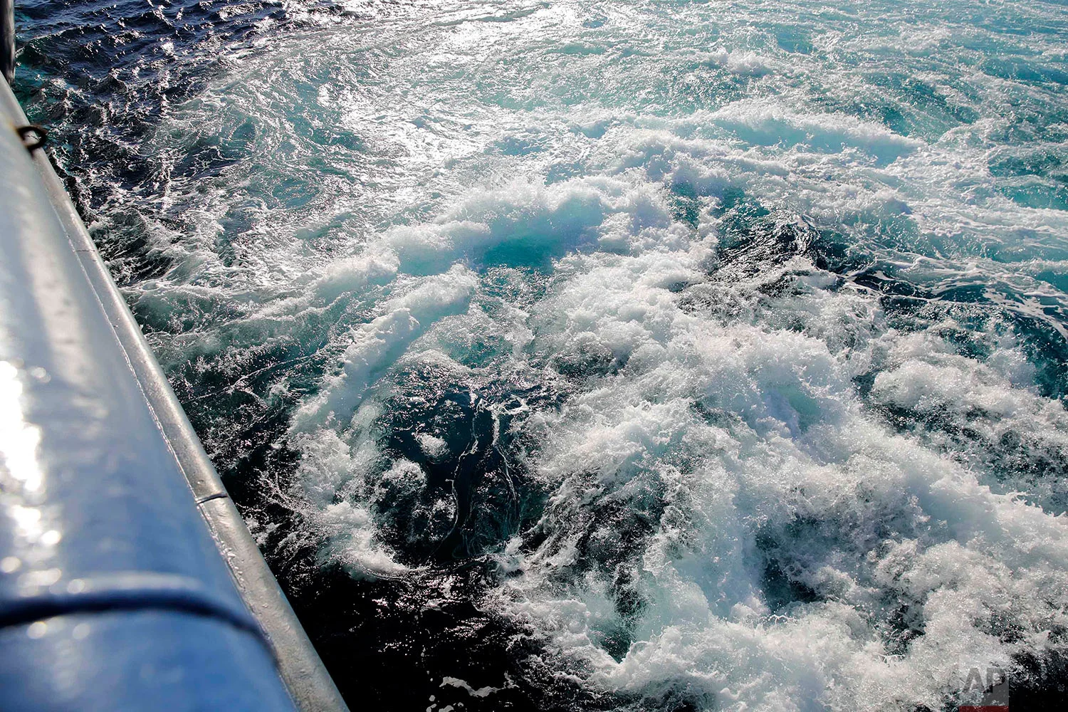 The thruster current of the Finnish icebreaker MSV Nordica churns water as the ship turns to demonstrate its maneuverability while sailing the Dolphin and Union Strait off the coast of Canada through the Arctic's Northwest Passage, Wednesday, July 19, 2017. The thrusters can break ice up to one one meter thick by churning the water underneath. (AP Photo/David Goldman)