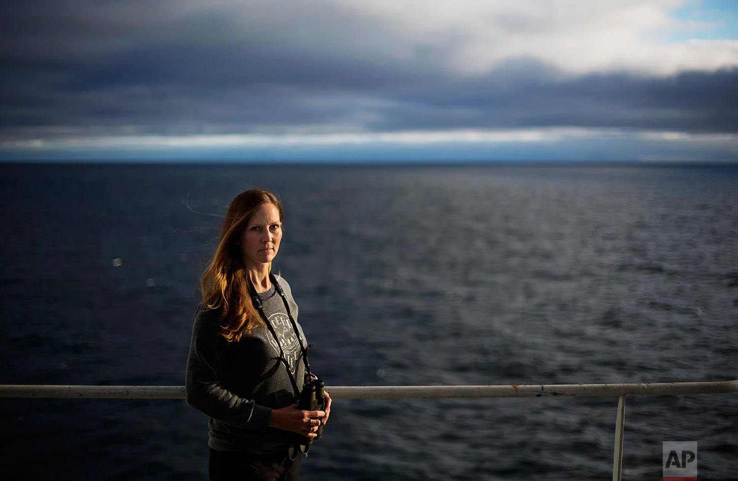 Field biologist Paula von Weller, 45, of Portland, Ore., stands for a portrait aboard the Finnish icebreaker MSV Nordica as it sails in the North Pacific Ocean toward the Bering Strait, Tuesday, July 11, 2017. "Few people in the world get to sail the Northwest Passage," said von Weller, who will be marking her second passage after traveling through with another Finnish icebreaker in 2015. She is observing wildlife in the Arctic and hopes this time to see the elusive narwhal, the unicorn of the sea. "I've been fascinated with the Arctic. It is very special to me. I think it's just this mythical place." (AP Photo/David Goldman)