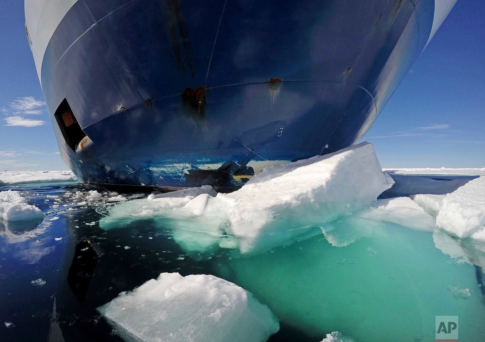  The bow of the Finnish icebreaker MSV Nordica pushes down sea ice as it sails through the Victoria Strait while traversing the Arctic's Northwest Passage, Friday, July 21, 2017. The MSV Nordica is equipped with several heavy-duty engines and a harde